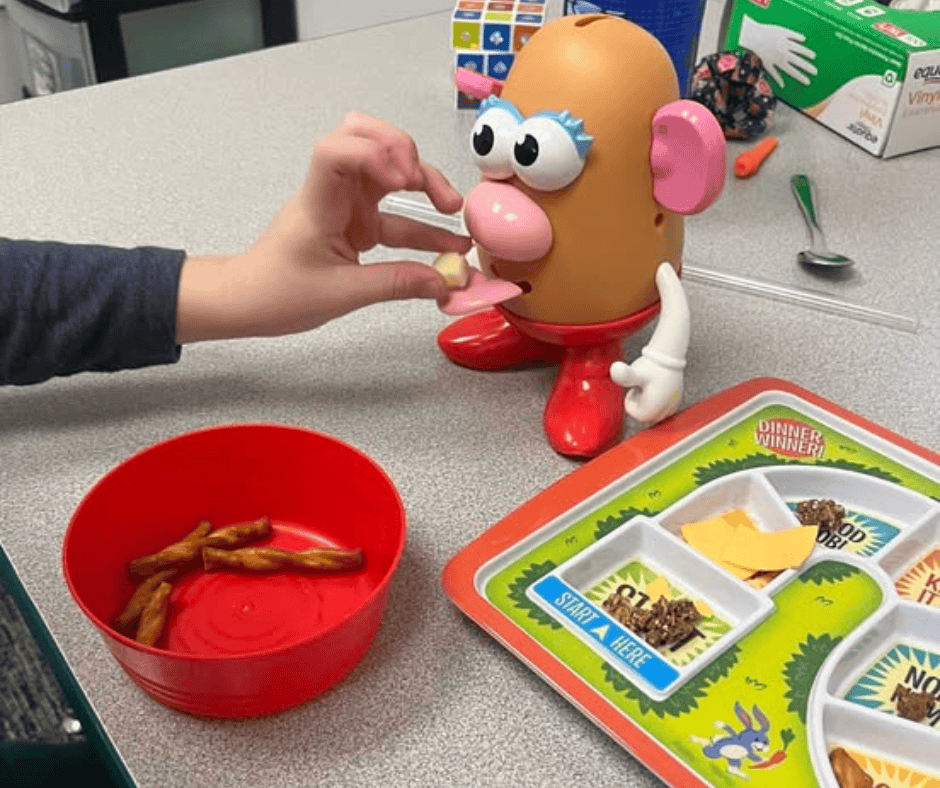 Occupational Therapist working with a kid and playing with magnetic fish