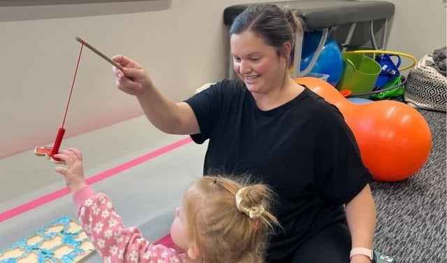 Occupational Therapist and Child doing therapy through play with fish game